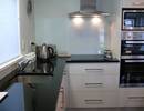 Black granite benchtop with wall oven unit